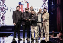 Team members from IVG stand on a stage and accept the 'Innovation of the Decade' award at the Vapouround Global Awards 2025 in Dubai.