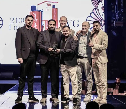 Team members from IVG stand on a stage and accept the 'Innovation of the Decade' award at the Vapouround Global Awards 2025 in Dubai.