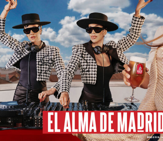 Madrí Excepcional celebrates the Soul of Madrid in new TV campaign Promotional image for Madri Excepcional 2025 summer campaign with two women working on a DJ set whilst dancing, a person holds a Madri pint glass in the foreground with beer inside the glass.