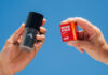 A person holds a Rock Face Deodorant Refillable container with a Rock Face Refillable Deodorant Power pack in the other hand.