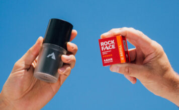 A person holds a Rock Face Deodorant Refillable container with a Rock Face Refillable Deodorant Power pack in the other hand.