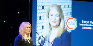 Sonya Harper, chief operating officer at Spar Scotland, stands at a podium delivering a speech during the Spar Tradeshow event.