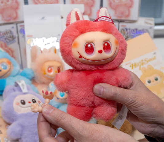 Trading Standards warns of dangers from counterfeit Labubu Dolls A person holds a red Labubu doll in one hand with small pieces from the doll in the other hand.