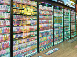 Glass cabinet of vaping products lined up against a store wall.