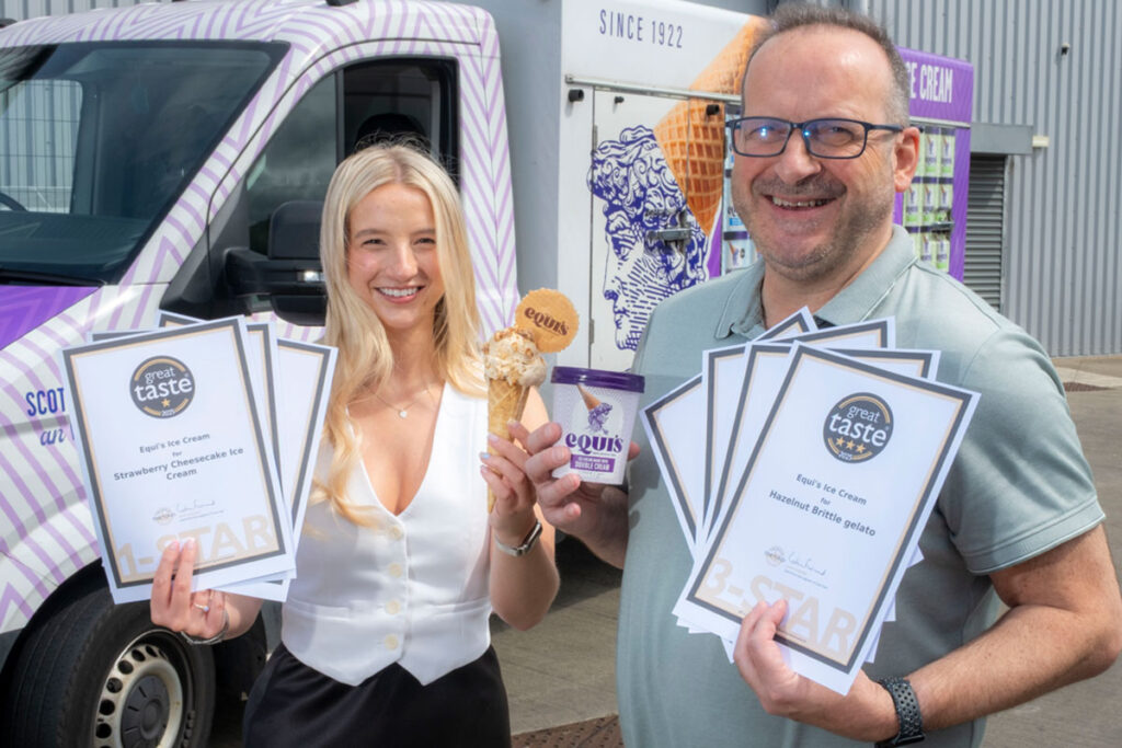 Alex and David Equi stand holding certificates for Great Taste Awards for their products as well as a commercial tub of the brand's ice cream.