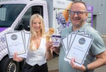 Alex and David Equi stand holding certificates for Great Taste Awards for their products as well as a commercial tub of the brand's ice cream.