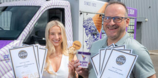 Alex and David Equi stand holding certificates for Great Taste Awards for their products as well as a commercial tub of the brand's ice cream.