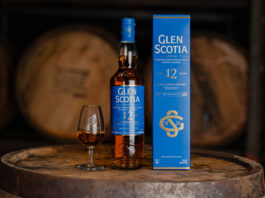 Glen Scotia flies the flagship with new 12 Year Old whisky A bottle of Glen Scotia 12 Year Old stands next to its outer box packaging with a dram of the whisky inside a nosing glass next to it. All three stand on top of a barrel.