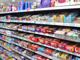 Inflation continues to tick upwards Confectionery aisle inside of a Day-Today store showcasing a vast array of chocolate bar options.