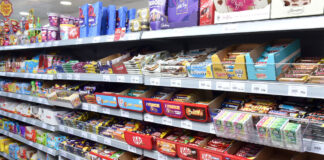 Confectionery aisle inside of a Day-Today store showcasing a vast array of chocolate bar options.