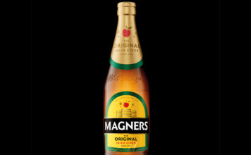Bottle of 2025 redesign for Magners cider against a black background.