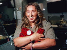 Sophie Williams stars in major Coca-Cola campaign around convenience stores Edinburgh retailer Sophie Williams stands holding cans of Coca-Cola Zero Sugar in her arms.