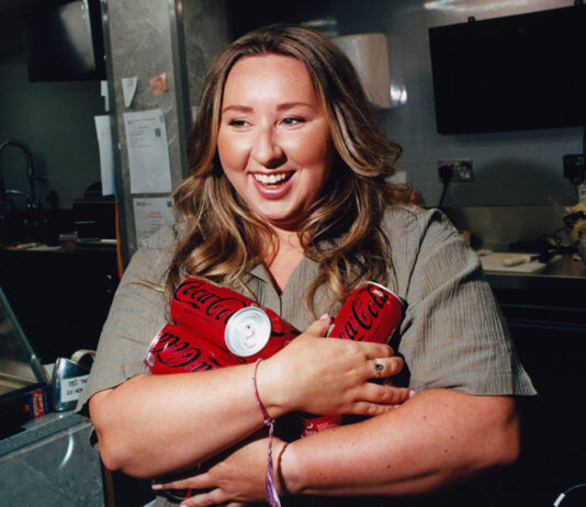 Sophie Williams stars in major Coca-Cola campaign around convenience stores Edinburgh retailer Sophie Williams stands holding cans of Coca-Cola Zero Sugar in her arms.