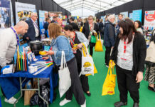 A group of people between stands at the Spar Scotland Tradeshow 2024.