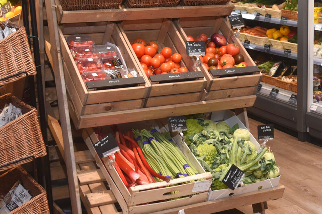 Fresh fruit and veg display making use of wooden boxes.