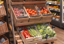 Fresh fruit and veg display making use of wooden boxes.