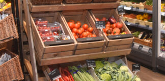Fresh fruit and veg display making use of wooden boxes.
