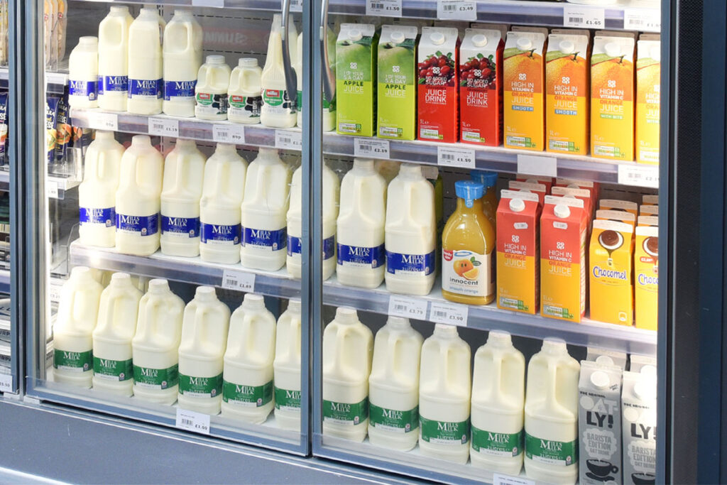 A store chiller filled with milk drink products, fruit juices and milk alternative options.