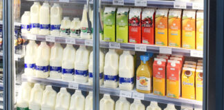A store chiller filled with milk drink products, fruit juices and milk alternative options.