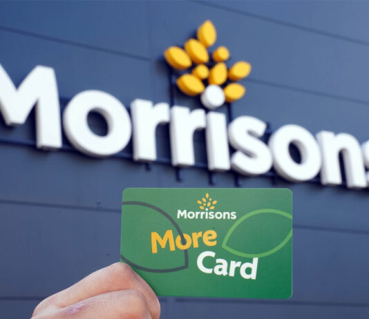 Morrisons launches new promotion for Daily stores A person holds up a Morrisons More card against a Morrisons sign which is on a building with black panelling.