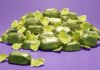 A pile of green wrapper chocolates for Quality Street boxes, the chocolate's flavour is to remain a mystery until December 2025.