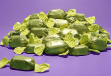 A pile of green wrapper chocolates for Quality Street boxes, the chocolate's flavour is to remain a mystery until December 2025.