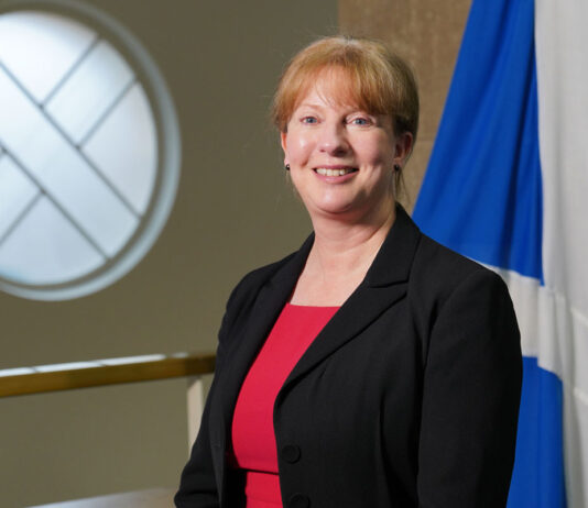 Scottish budget pushed to January Scottish finance secretary Shona Robison stands in Parliament with the Scotland flag behind her.