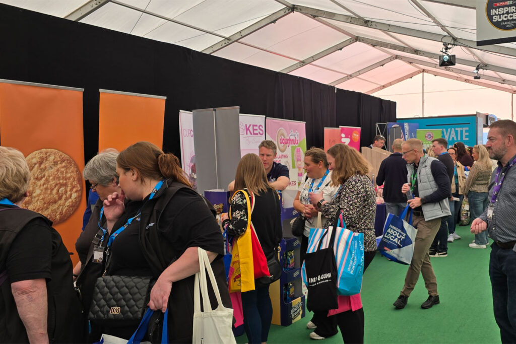 A group of people attend stands inside a tent during the Spar Tradeshow in Aviemore.