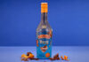 Baileys teams up with Terry’s Chocolate Orange for indulgent Christmas treat A bottle of Baileys Terry's Chocolate Orange limited edition flavour stands in front of a blue background with orange peel and pieces of chocolate around the bottle.