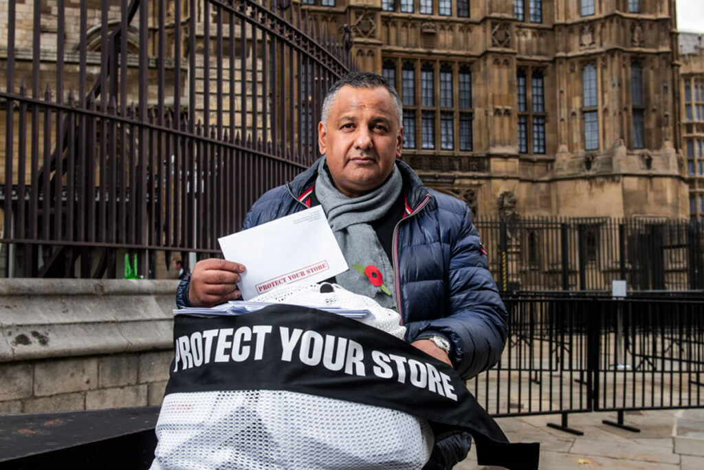 Paul Cheema, founder of C-Talk, stands in front of Westminster with a bag of signed letters from retailers against the Tobacco & Vapes Bill.
