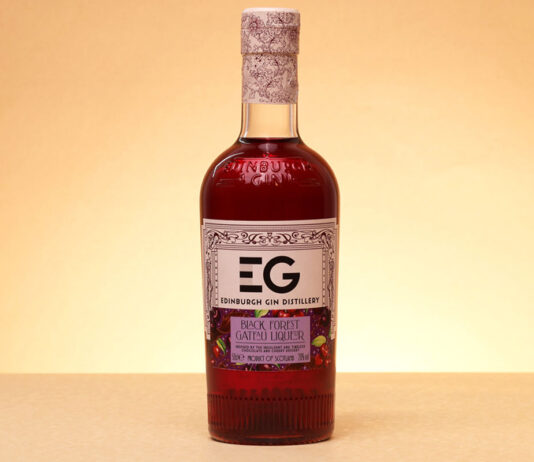 Edinburgh Gin unveils new Black Forest Gateau liqueur A bottle of Edinburgh Gin Black Forest Gateau Liqueur stands against a lit up background.
