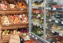 Food and drink inflation eases for the first time since March Fruit and veg stalls in a shop as well as a chiller filled with products.