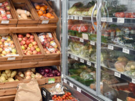 Food and drink inflation eases for the first time since March Fruit and veg stalls in a shop as well as a chiller filled with products.