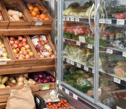 Food and drink inflation eases for the first time since March Fruit and veg stalls in a shop as well as a chiller filled with products.