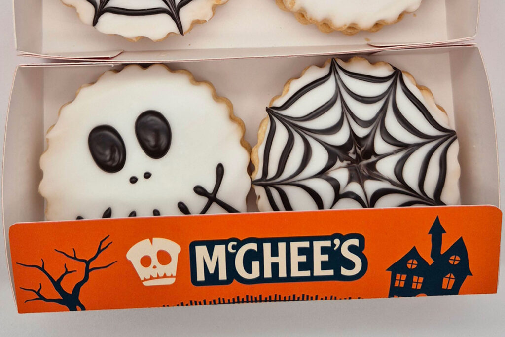 Pack shot of McGhee's Halloween Empire Biscuits with skull and spiderweb designs on them.