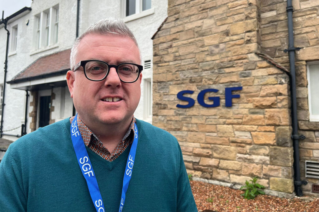 Luke McGarty, head of policy and public affairs at the Scottish Grocers' Federation, stands out side the HQ of the industry body.