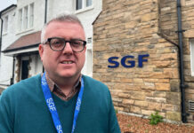 Luke McGarty, head of policy and public affairs at the Scottish Grocers' Federation, stands out side the HQ of the industry body.