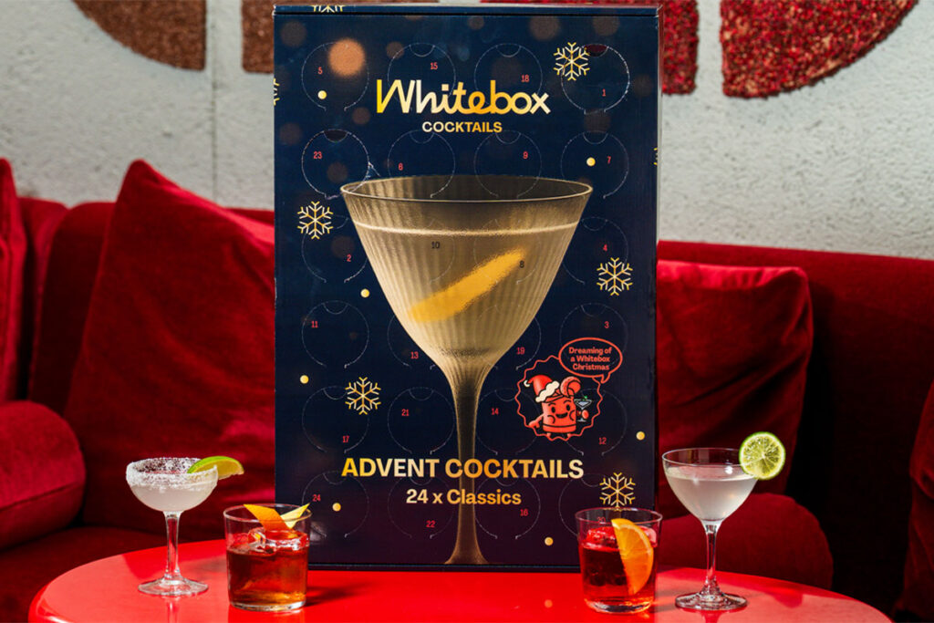 The Whitebox Cocktails advent calendar stands on a table with cocktail serves around the calendar.