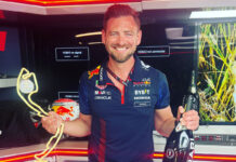 Bradley Scanes takes on director role at AG Barr Bradley Scanes, former Formula One coach, stands holding a bottle of champagne in one hand and a trophy in the other.