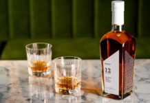 The Cairn Distillery encourages exploration with blended malt whisky range A bottle of CRN57 12 Years Old Blended Malt Scotch Whisky with two drams served in glasses next to the bottle. All of this is sitting on top of a marble tabletop.