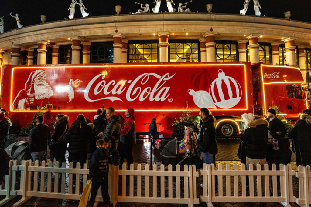 The Coca-Cola branded Christmas truck is parked up in London with a queue of people around it to visit the staple of the season.