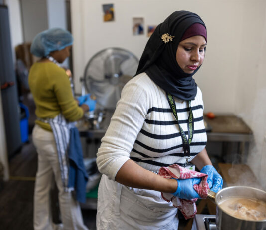 Don’t let good food go to waste A person stands in a kitchen cooking food in a pot.