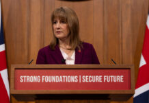 Employer national insurance contributions frozen as OBR leaks Autumn Budget details Rachel Reeves stands at a podium in parliament.
