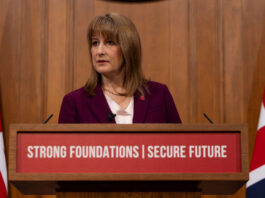 Employer national insurance contributions frozen as OBR leaks Autumn Budget details Rachel Reeves stands at a podium in parliament.