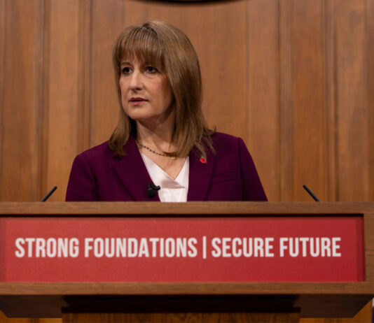 Employer national insurance contributions frozen as OBR leaks Autumn Budget details Rachel Reeves stands at a podium in parliament.