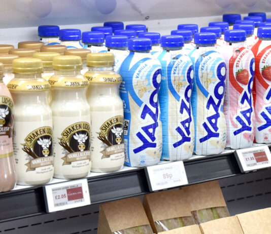 Soft drinks levy charges to change Bottles of milk-based drinks lined up in a chiller shelf.