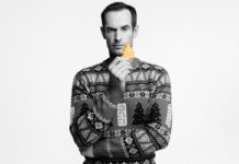 Walker’s Shortbread and Andy Murray knit in some festive cheer with Christmas jumper campaign Andy Murray stands holding a piece of Walker's Shortbread whilst wearing the Walker's Shortbread Christmas jumper in a black and white image.