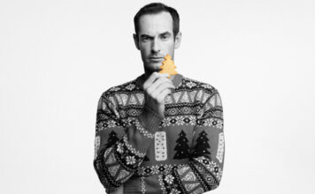 Walker’s Shortbread and Andy Murray knit in some festive cheer with Christmas jumper campaign Andy Murray stands holding a piece of Walker's Shortbread whilst wearing the Walker's Shortbread Christmas jumper in a black and white image.