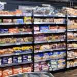 Inflation falls to lowest rate in eight months A bread and bakery section inside of a convenience store.