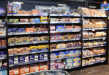 Inflation falls to lowest rate in eight months A bread and bakery section inside of a convenience store.